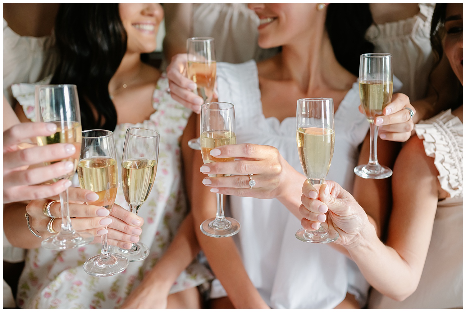 bride and bridesmaids cheering with champagne toast