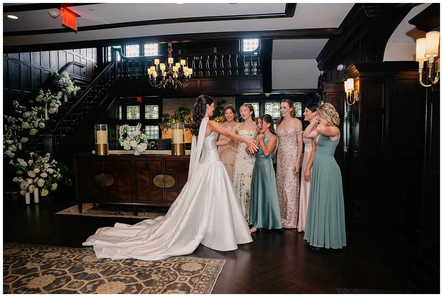 brides pretty first look with bridesmaids