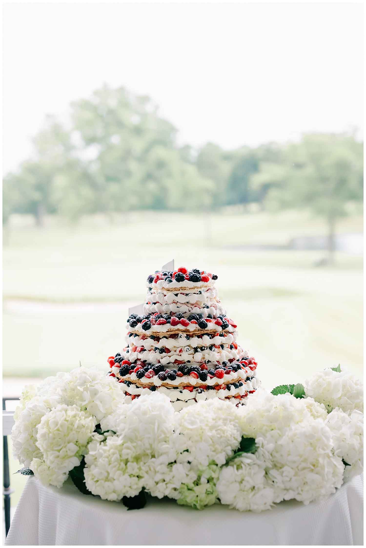 beautiful french pastry wedding cake with blueberries and raspberries