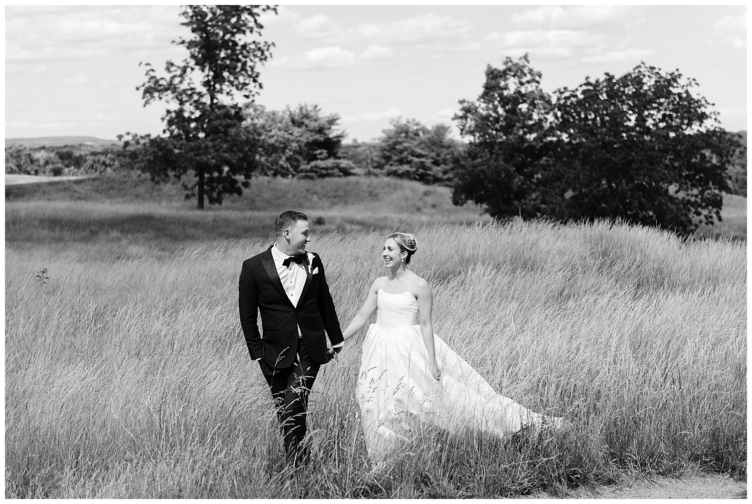 Bride and groom portrait in tall grass at Fiddler's Elbow Country Club Bedminster NJ