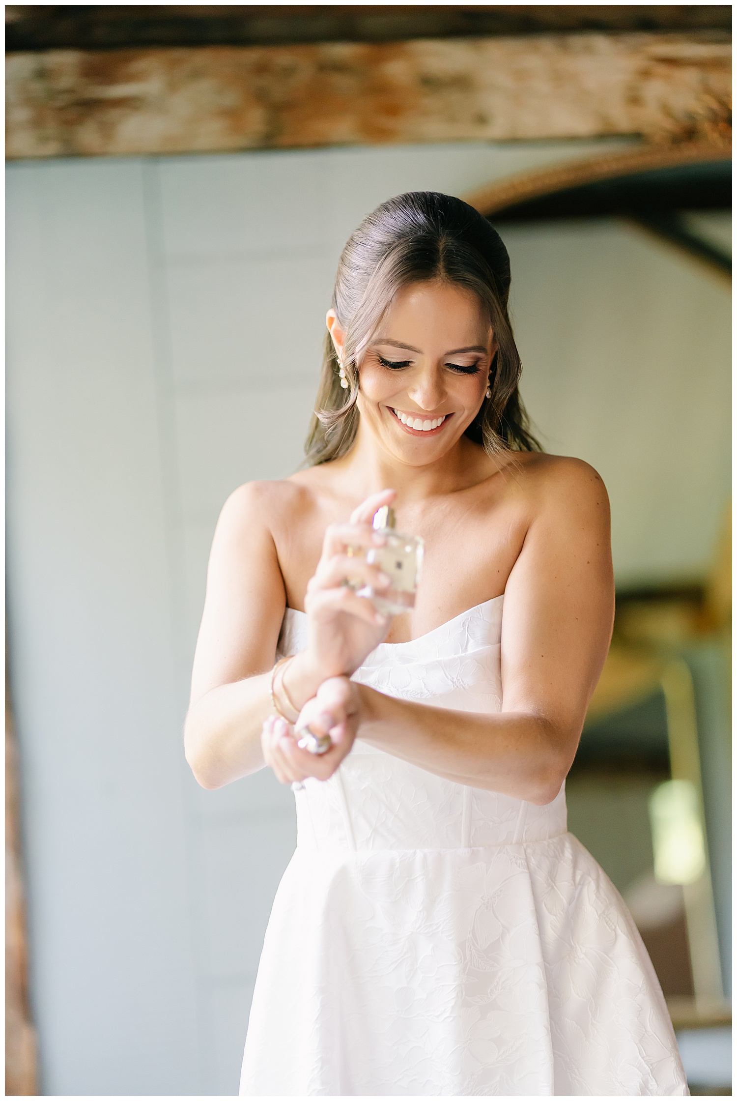 bride spraying on her favorite perfume on her wedding day