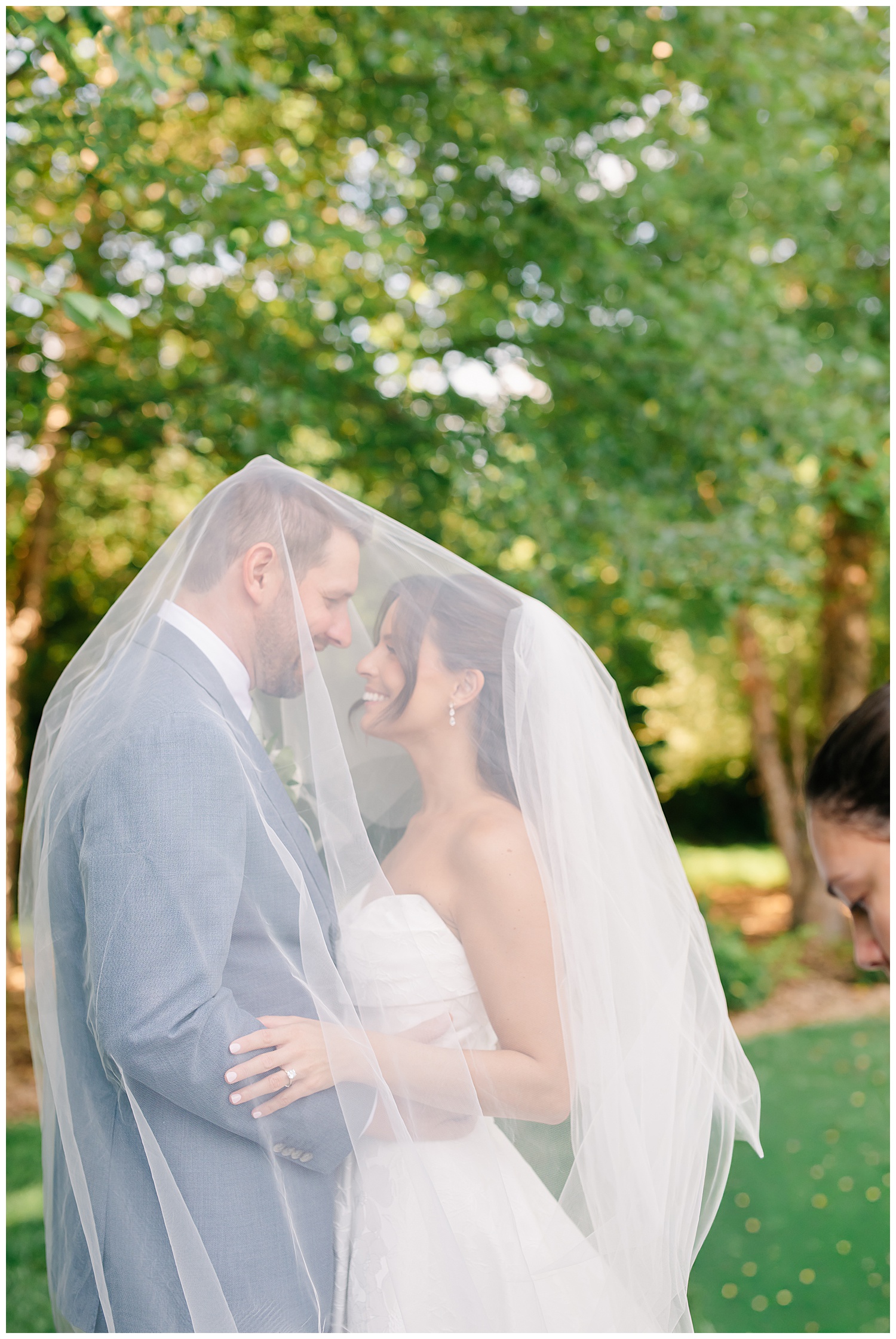 bride and groom portrait under bridal veil