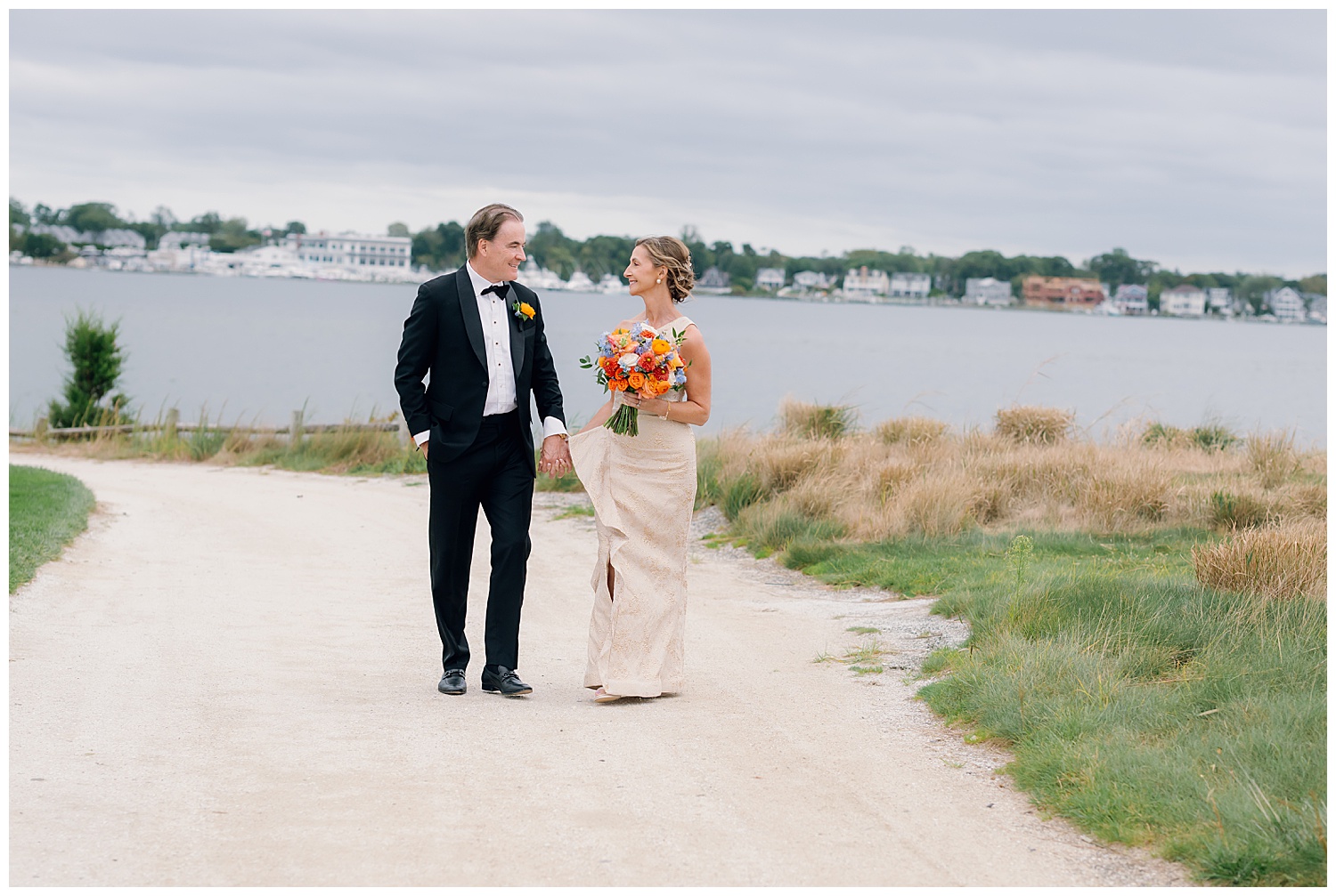 bride and groom walking on beach for portraits