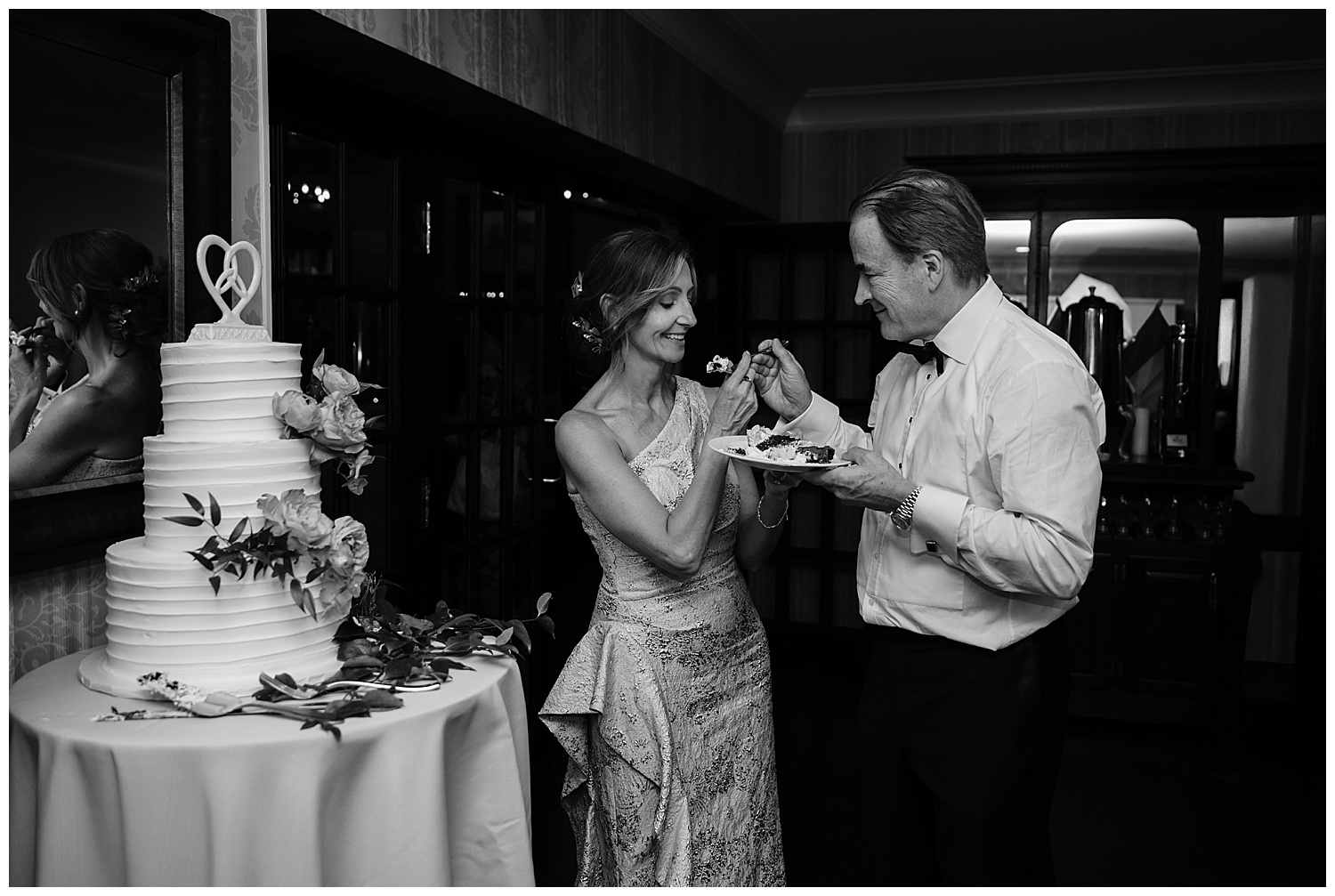 bride and groom cutting their wedding cake